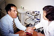 TCM doctor is examining the patient's tongue and feeling his pulse.